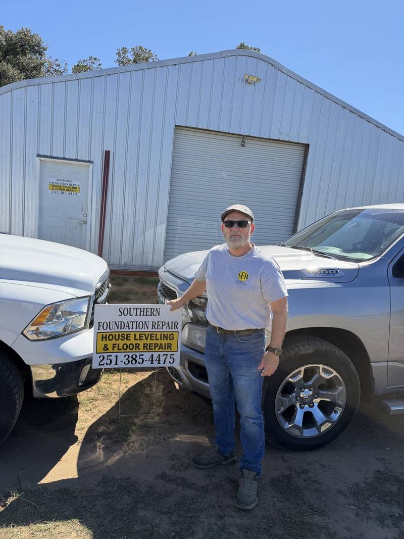 Tony Wilks at the SFR shop with the company trucks